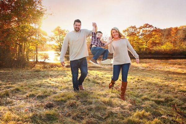 Family Photographer in Portsmouth New Hampshire little boy being swung in the air by parents in durham New Hampshire