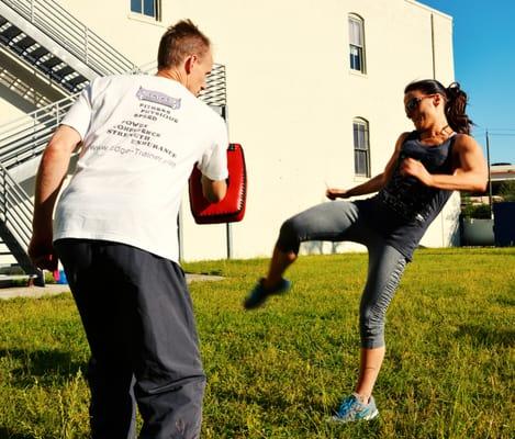 Warming up outside with some Muay Thai kicking.