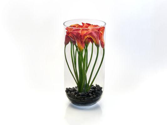 Glass Calla Tower - A tall significant barrel vase filled with black Spruce rocks, H2O, and a grand topiary of Calla Lilies.