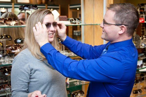 Fitting sunglasses on a happy patient