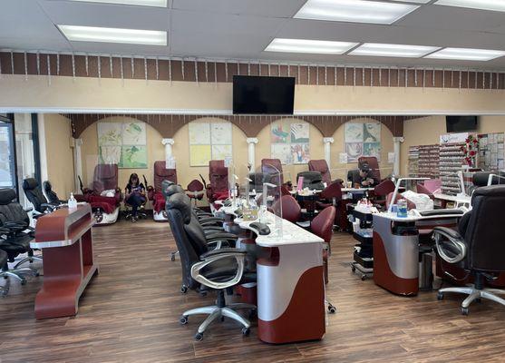 Front of shop. Lots of stations for pedicures and manicures.