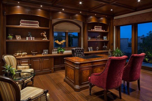 The  library is warm and welcoming, due built in cabinetry and paneled wainscot, along with a wood coffered ceiling