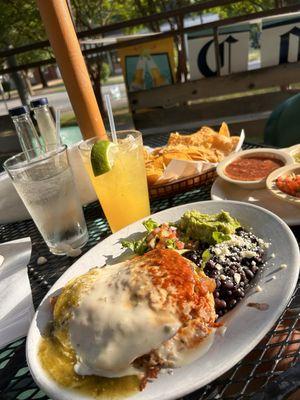 Stacked chicken enchiladas, black beans and guacamole and pico salad.