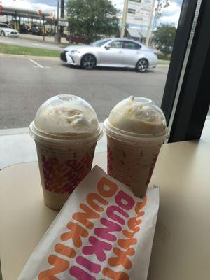 Two iced blueberry crisp latte and our car in the background lol