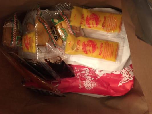 Opening the bag , The food came with plenty of sides, and extra soy sauce and mustard