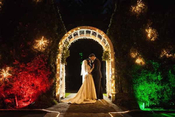 Bride and groom under arch