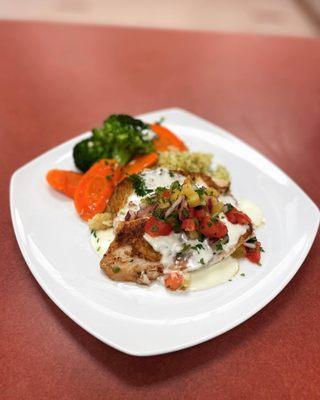 Blackened tilapia with sautéed vegetables, cilantro rice, pineapple pico de galló and lemon butter sauce.