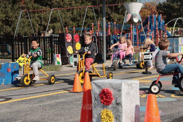 Young Explorers created a Safety Town then practiced their tricycle skills.