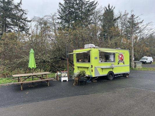 Table next to food truck.