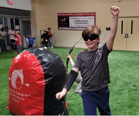 Kid feeling victorious after playing at DodgeBow Annapolis!