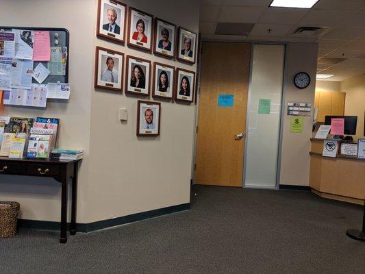 Waiting room with doctors' photos on the wall