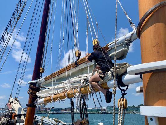 Isabella pulling and wrapping sails