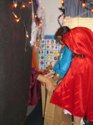 Red riding hood and her friend trick-or- treating in class.