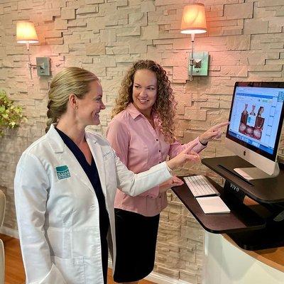 Dr. Marta Baird meets with Treatment Coordinator, Erin, to review patient photographs before each virtual consult.