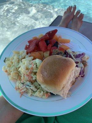 Hawaiian pulled pork slider with slaw, macaroni salad and fruit.