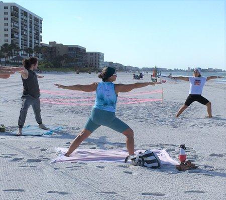 A sea turtle nest is the backdrop in this photo.  It is turtle nesting season and we are honored to see nests up and down our beaches.