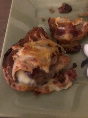 Potato skins cooked through full of bacon soo good I forgot to take pict before I devoured them !! Sides of sour cream and ranch dressing !