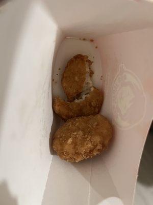 someone took a bite out of chicken nugget and put it at the bottom