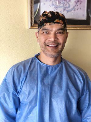 Dr. Galvan smiling and getting ready to see his next patient.