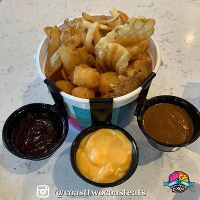 Bucket of fries with bbq sauce, beer cheese, and chocolate mole dipping sauces