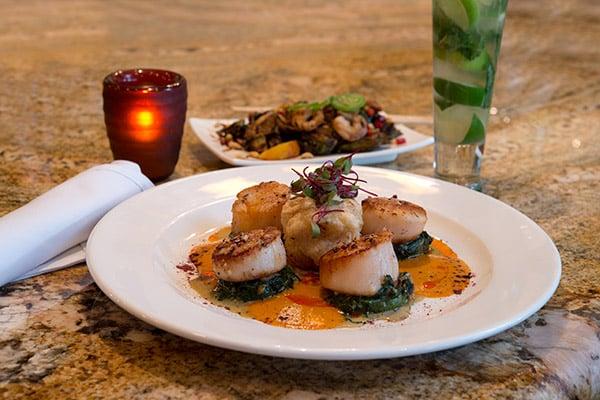 SEARED U-8 DIVER SCALLOPS*
 steamed clams, creamy sweet corn sauce
  pork belly, roasted vegetables pearl couscous