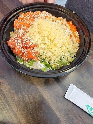 Poke bowl with green onion, masago, spicy salmon, spicy tuna, crunch, and the house sauce.