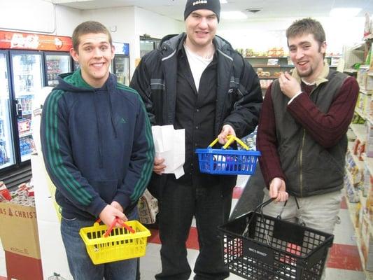 Eric P. standing in the middle makes a 3rd grade smile while showing off the different sized baskets available!