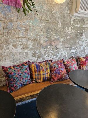 Inside seating, with colorful and beautifully embroidered pillows