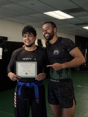 Coach Matt with our newest BJJ blue belt!