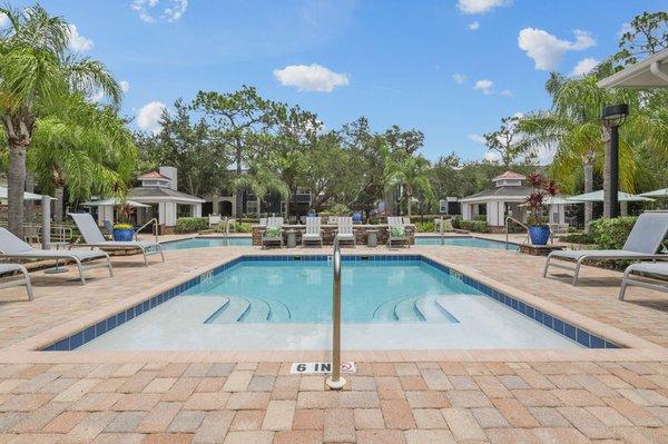 Image of resort-style pool and hot tub with sundeck and lounge chairs at Lantower Cypress Creek.