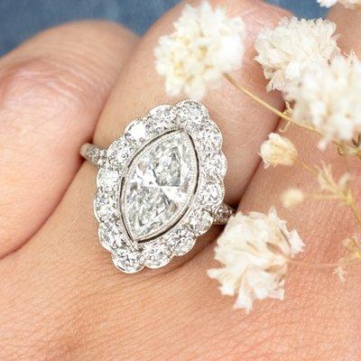 This absolutely breathtaking engagement ring features a GIA certified 1.92ct marquise cut diamond set in the middle of a diamond halo!