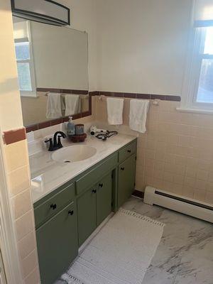 Green and white themed bathroom.