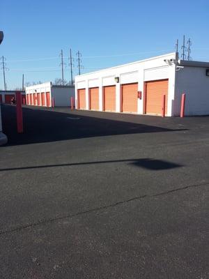 Small child riding a dirt bike in the lot.