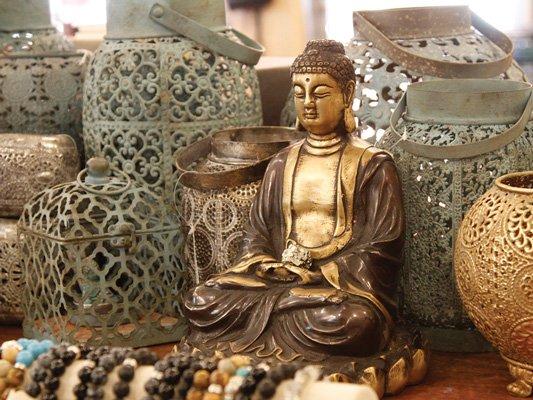 Many rustic metal lanterns and buddha statues