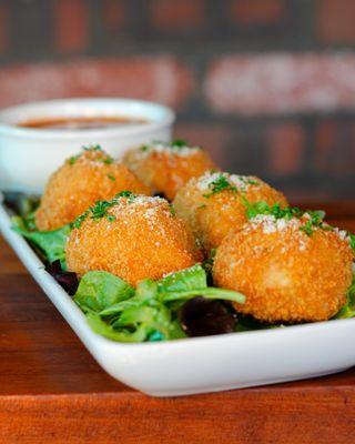 Golden balls of cheesy risotto.