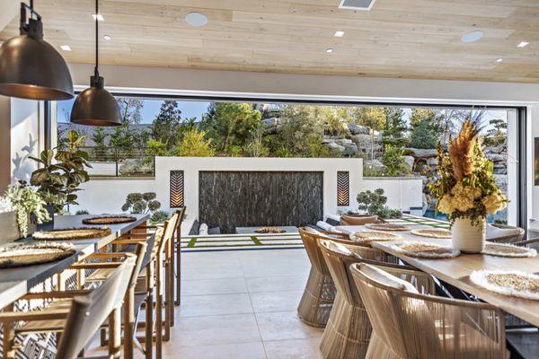 View from California room out to the weeping water wall with dekton fire pit