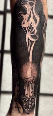 Black and gray realism candle tattoo. black out tattoo. smoke tattoo.