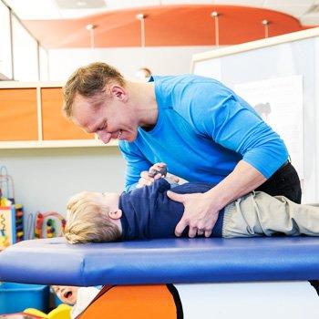 Dr. John Vincent adjusting a child