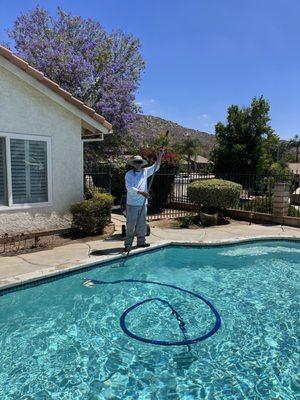 Full pool service where brushing of walls and chemical balancing is being done.