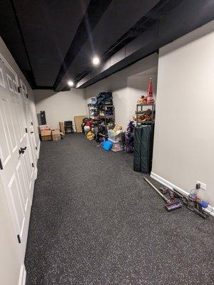 Basement storage area (rubberized flooring, installed ejector pit, installed closet for W/D hookup)