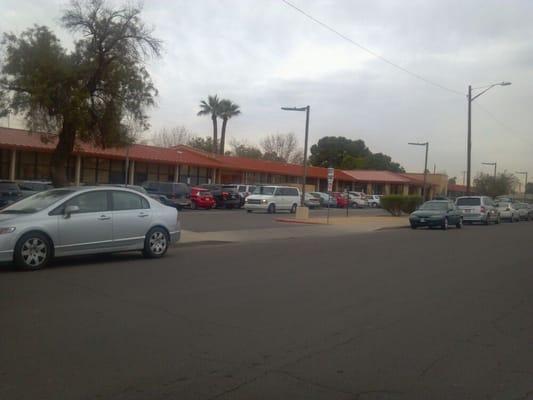 Wide shot of school at release time...cloudy day.