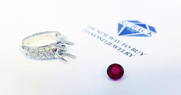 Loose natural red ruby and pave-diamond ring mounting.