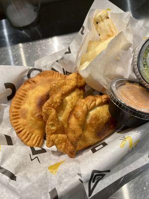 From left to right: picadillo beef, chicken curry, spiced chickpea, yuca bites, and their aji rojo and verde