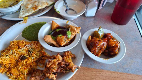 Veg biriyani, samosa chat, onion pakoda, gobi Manchurian, mint chutney