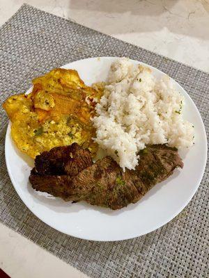 Flank Steak with sides of fried Plantains and rice