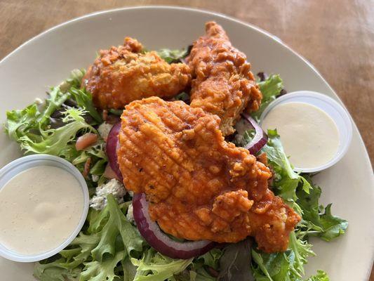 Buffalo chicken salad. So good! Chicken tossed in medium sauce, salad greens, tomatoes, red onion, & blue cheese crumbles.