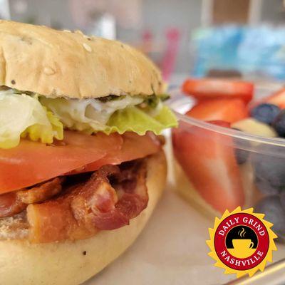 BLT on a toasted bagel with fresh seasonal fruit.