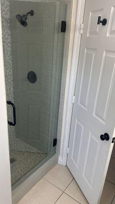 Swinging Shower glass door with black finishes