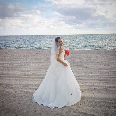 Huda created a bustle on this ballgown style wedding dress so that it would be more manageable on the beach!