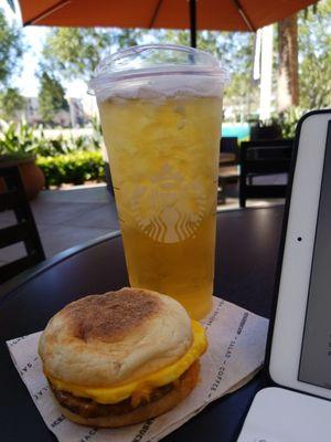 Iced green tea; sausage, cheddar, egg breakfast sandwich.